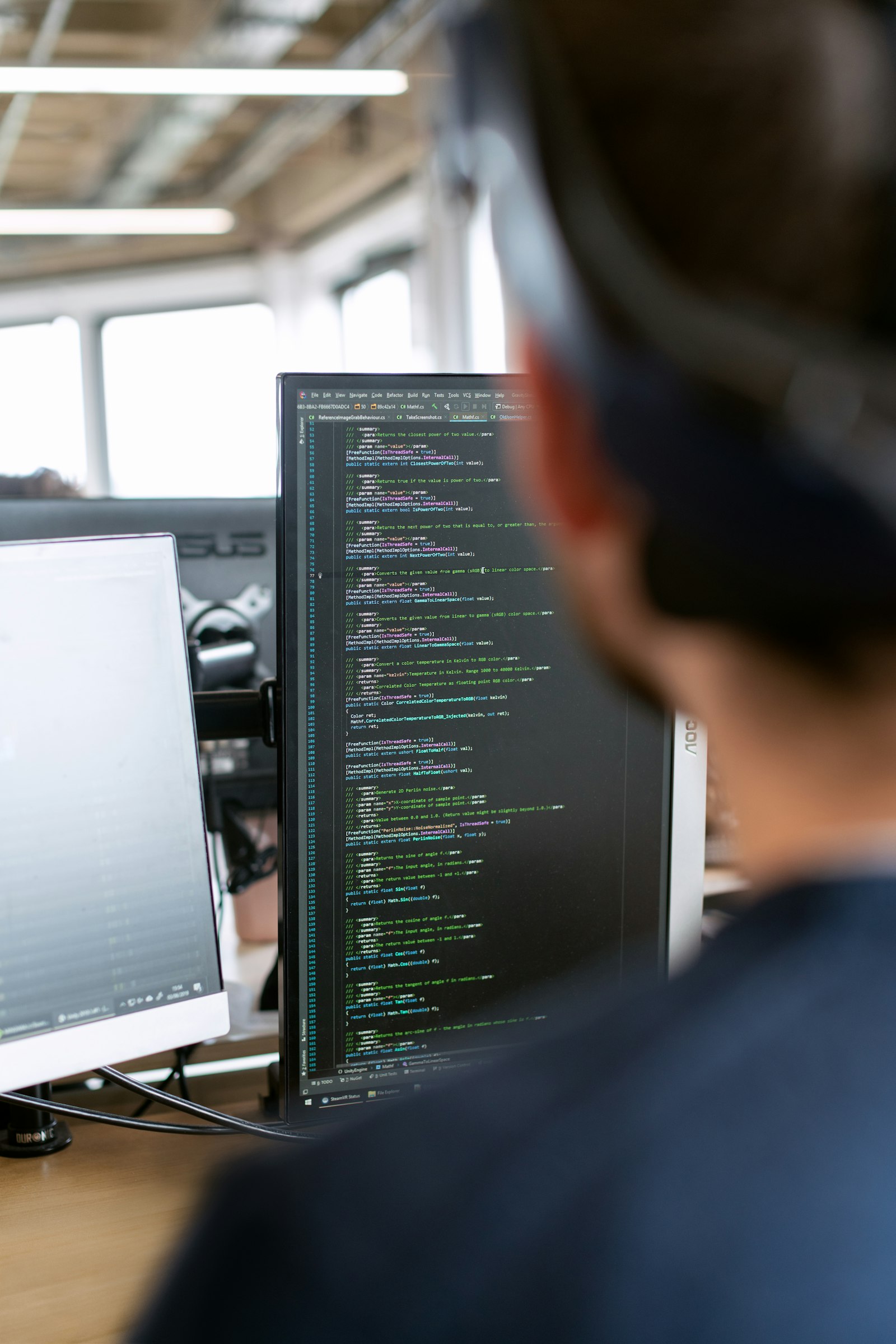 QA engineer testing a mobile app on multiple physical Android and iOS devices