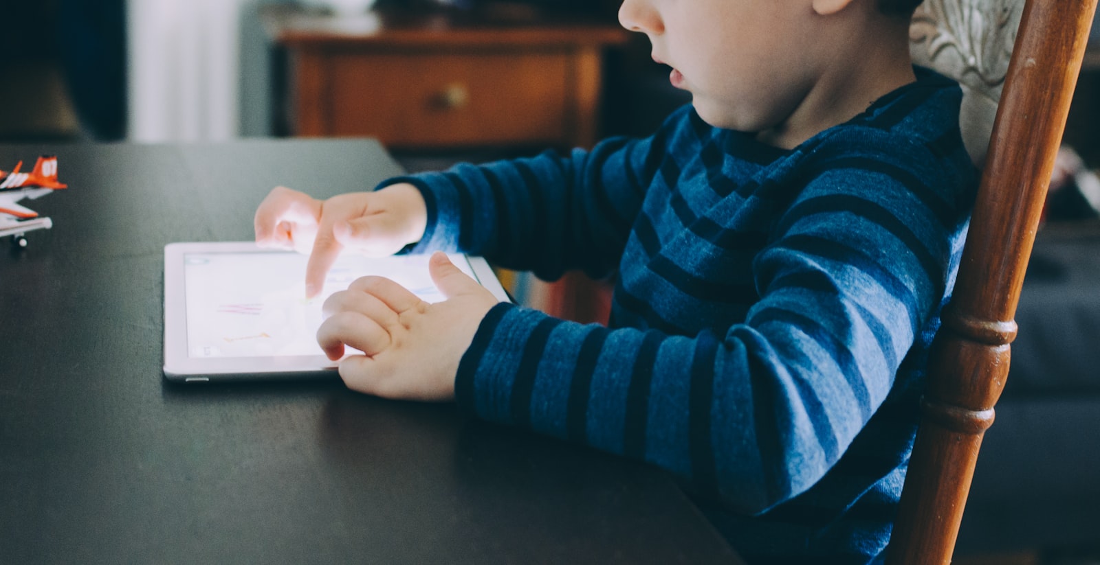 FERPA and COPPA compliance for edtech — a young child using a tablet at home