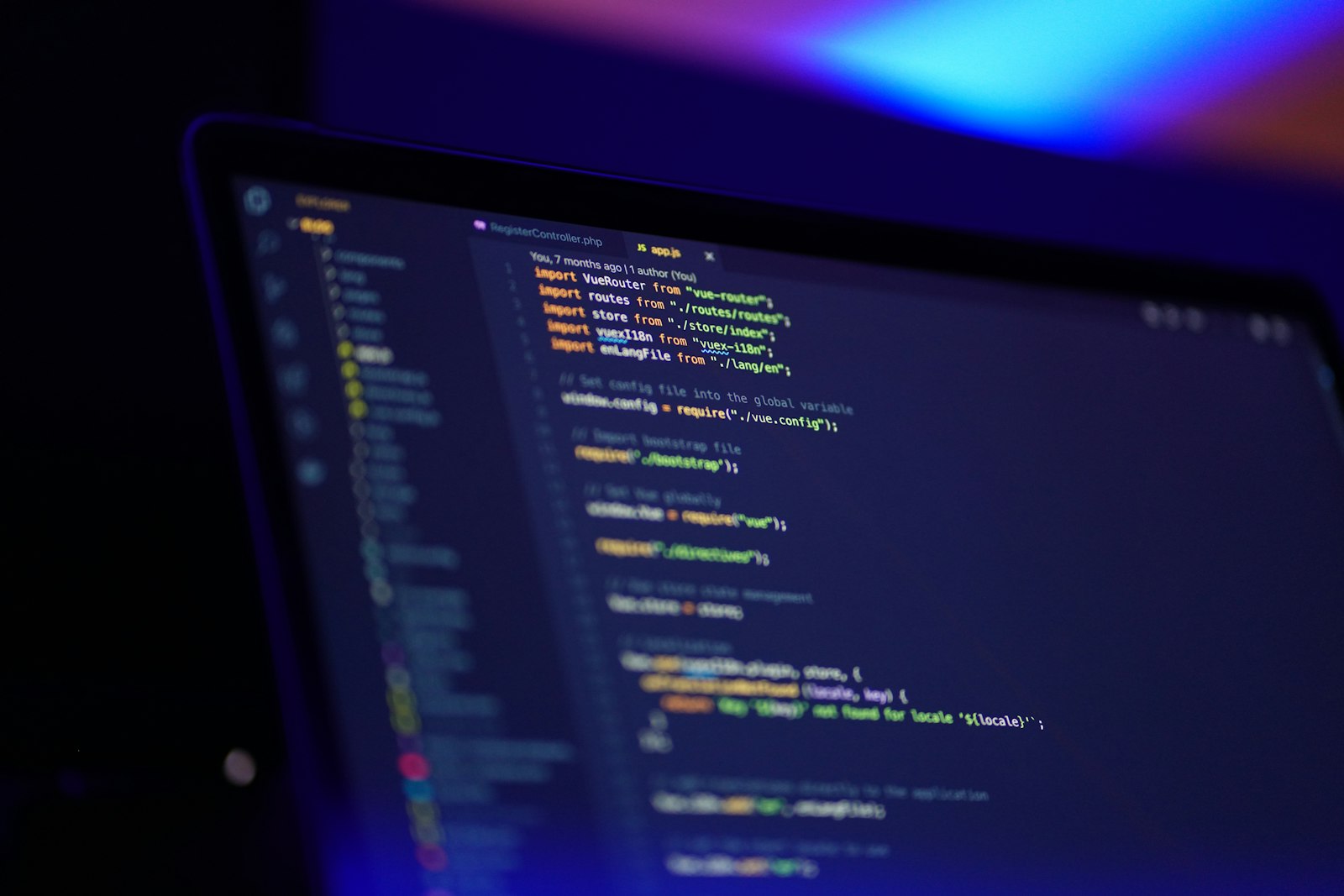 A code editor with application source on a laptop screen — building the retrieval and conversation layer that grounds an AI chatbot in a company's own knowledge base