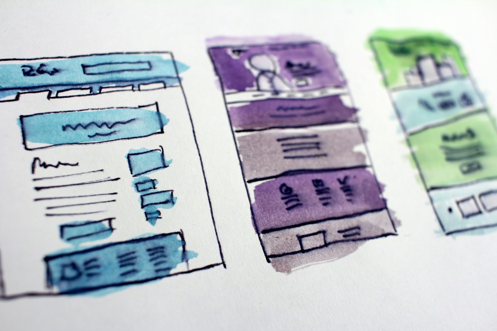 Designer reviewing wireframes and architecture diagrams during the design phase of software development