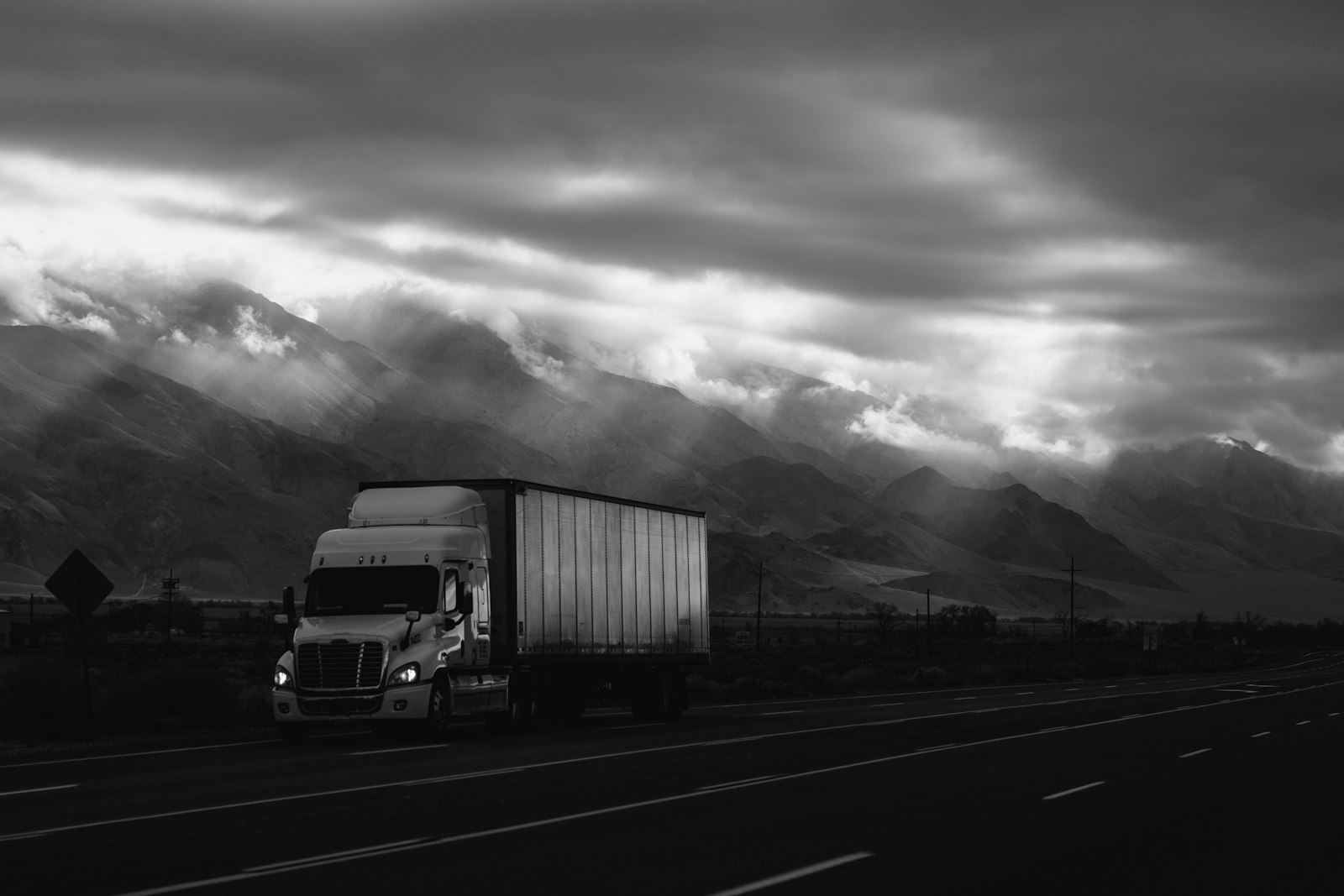 A freight truck on the highway — the 214 shipment-status updates that feed real-time visibility