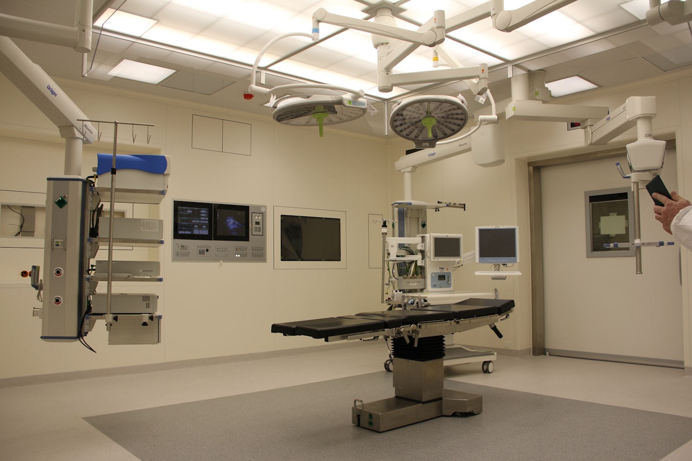 Hospital operating room with connected monitors and equipment representing the clinical systems healthcare software must integrate with