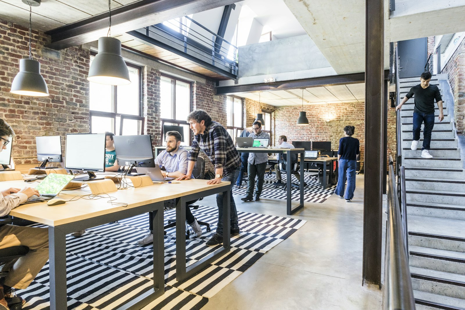 An agile software development team collaborating in an open-plan office during a sprint