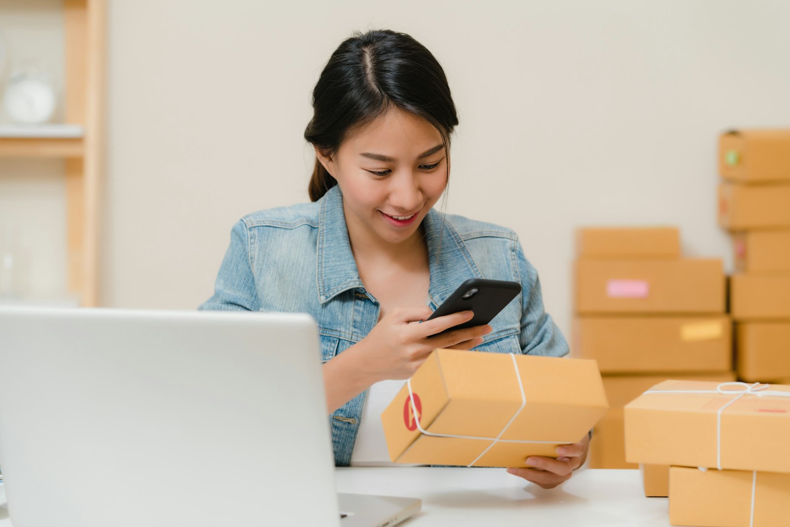 How to build an online marketplace — a seller packing orders at a laptop