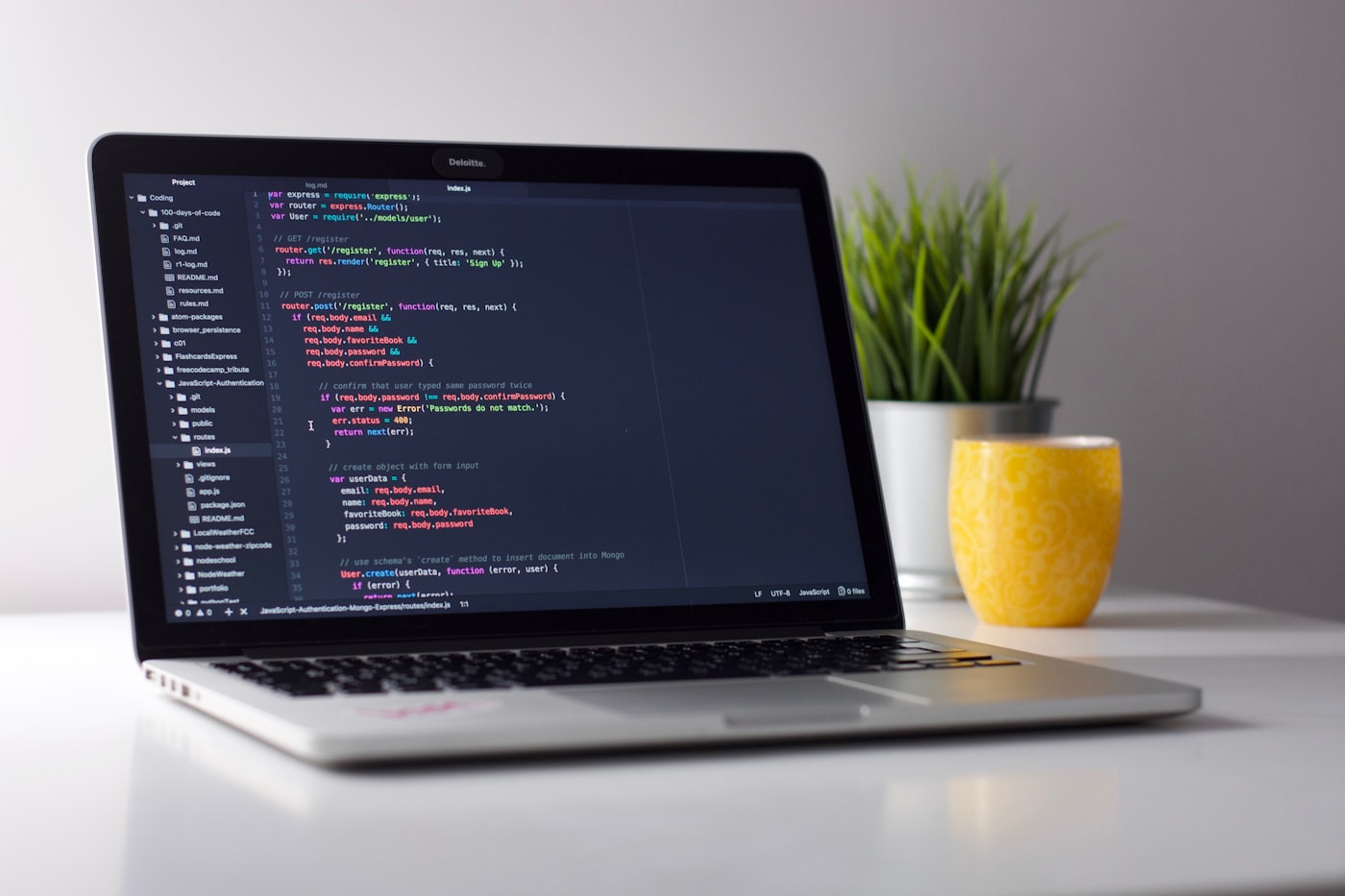 Developer reviewing code on a laptop before shipping to production