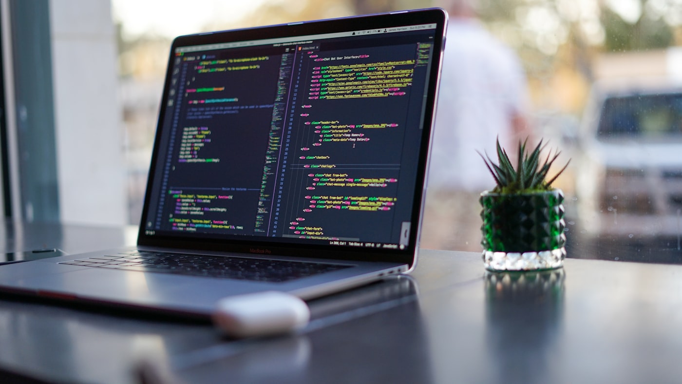 Developer writing full-stack web application code in a modern IDE with React and Node.js components